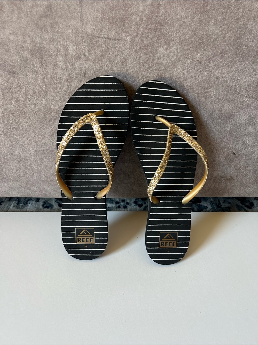Reef Women’s Black Striped Flip Flops with Gold Glitter Straps